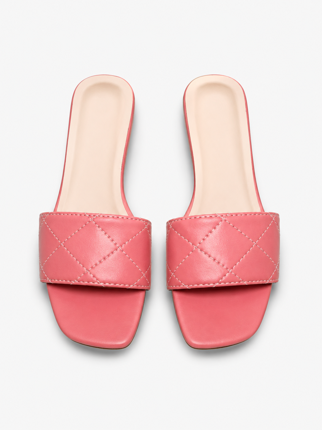 Pink quilted slide sandals flat lay